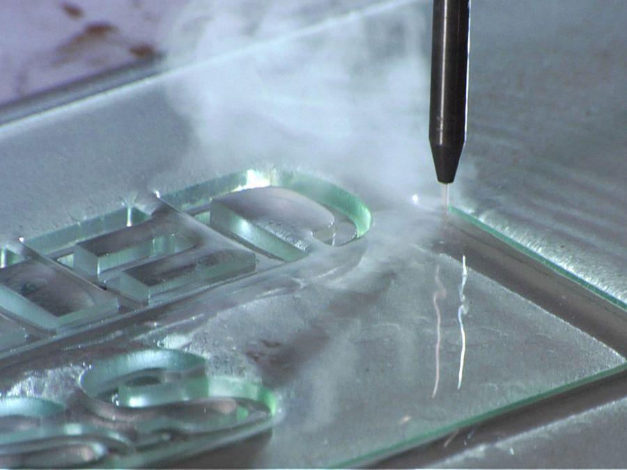 waterjet cutting intricate lettering in glass